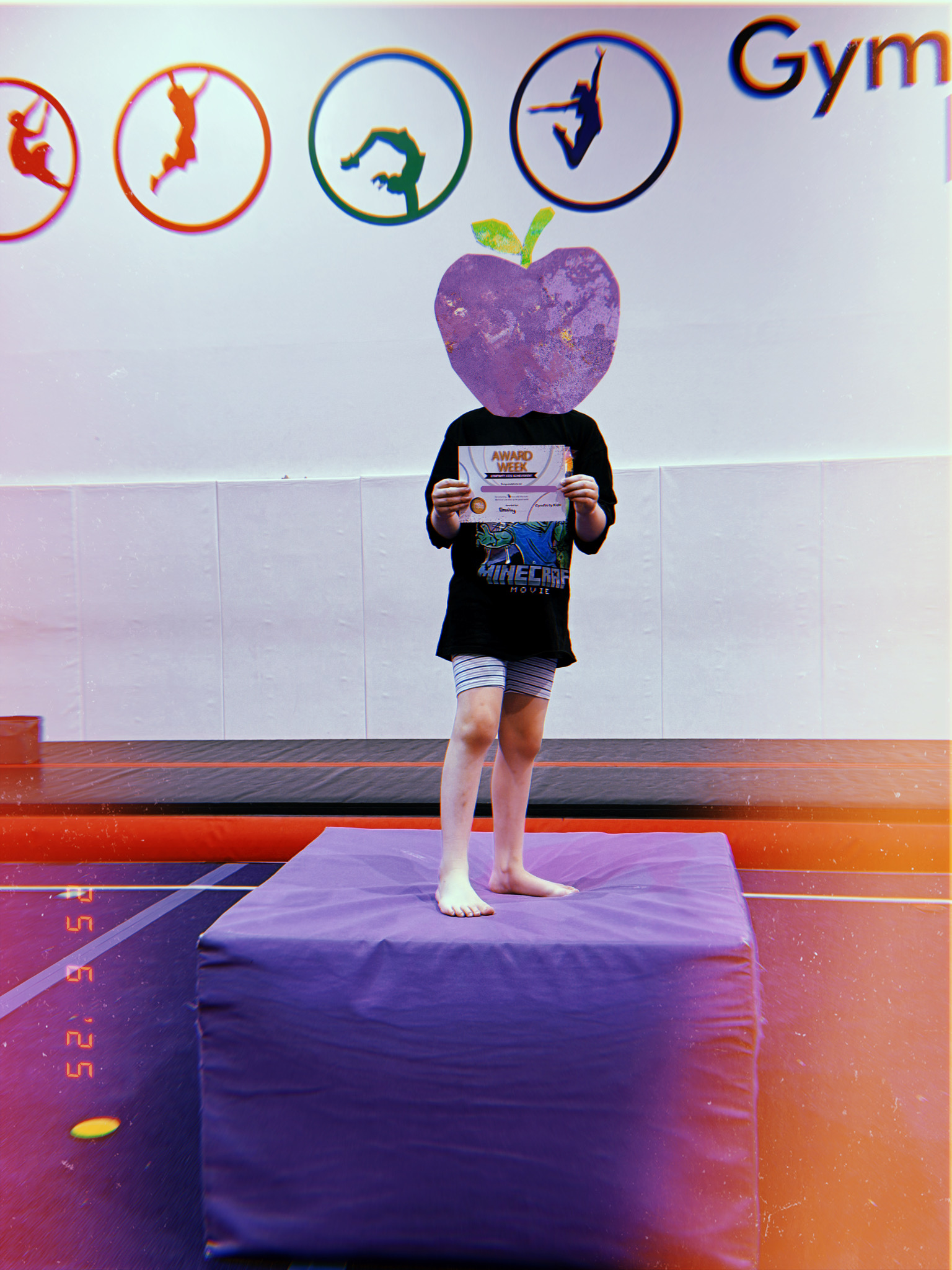 kid recieving certifiate at gym